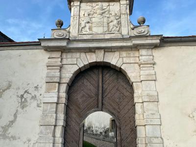 Close-up view of the stone entrance gate to Ptuj Castle showcasing intricate carvings.