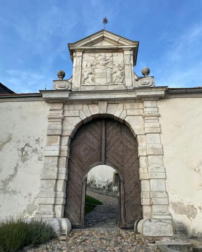 Close-up view of the stone entrance gate to Ptuj Castle showcasing intricate carvings.