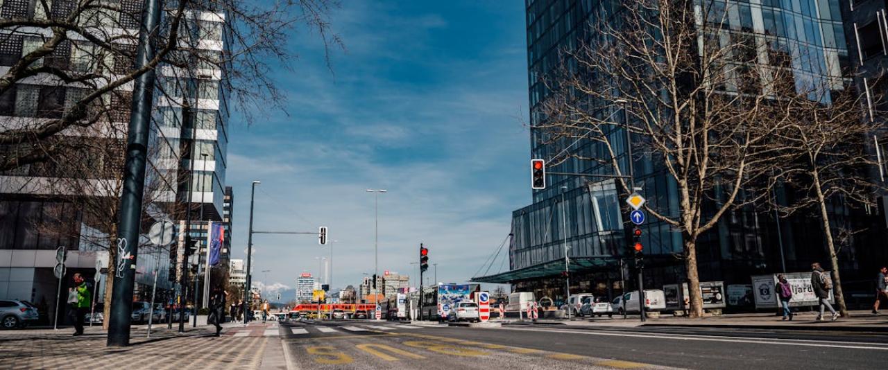 Vibrant urban street view with modern architecture and pedestrians in Ljubljana, Slovenia.