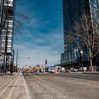Vibrant urban street view with modern architecture and pedestrians in Ljubljana, Slovenia.