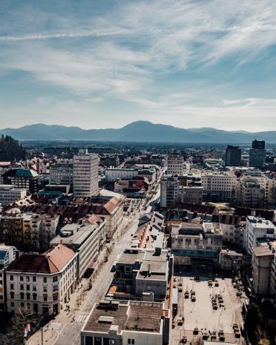 Free A stunning aerial view of Ljubljana, Slovenia featuring the city's buildings, castle, and surrounding mountains. Stock Photo