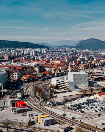 Skyline of Ljubljana with mountains in the backdrop, showcasing urban architecture.