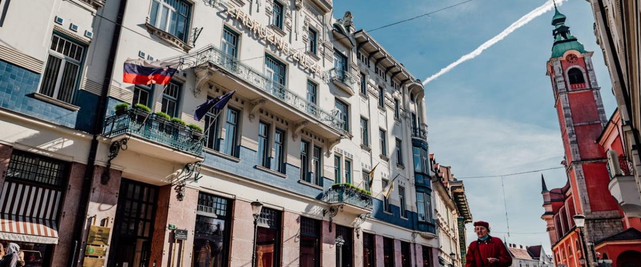 Explore the vibrant urban street scene of Ljubljana showcasing historic architecture and a bustling city atmosphere.