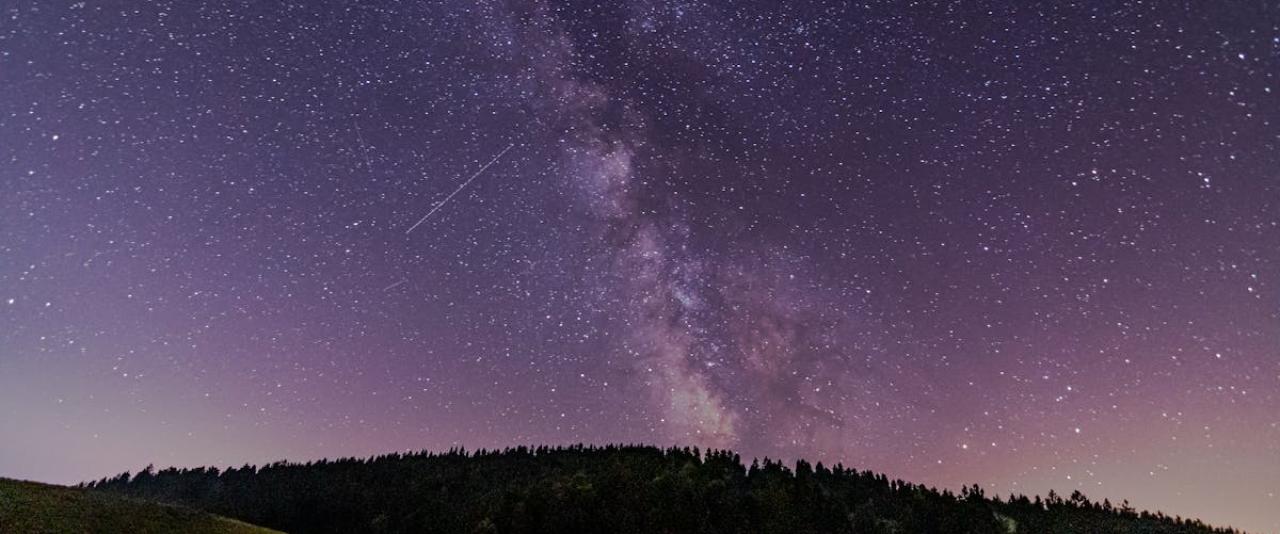 Breathtaking view of the Milky Way over a scenic landscape in Ljubljana, Slovenia.