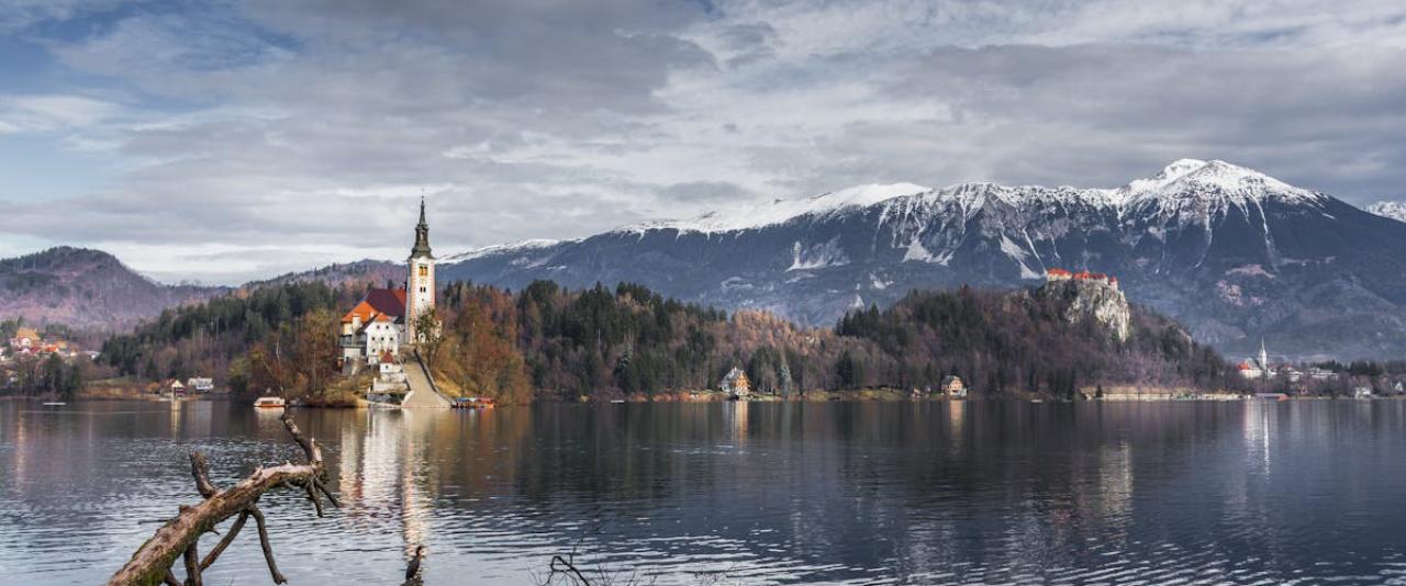 Serene winter landscape showcasing Lake Bled and the Alps in Slovenia.