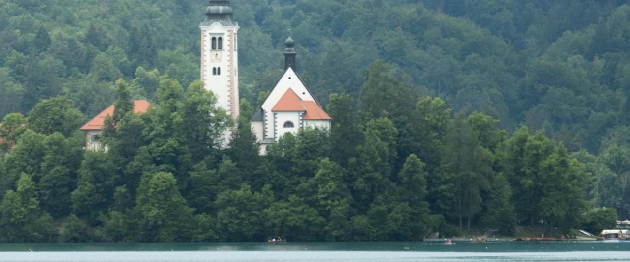 Free A serene boat ride on Lake Bled with the Church of the Assumption on Bled Island in the background. Stock Photo
