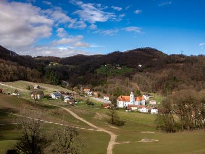 Picturesque landscape of Šmarje pri Jelšah with rolling hills and a traditional church.