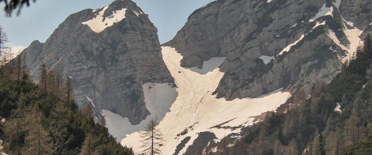 Majestic snow-covered mountains in Triglav National Park, Slovenia under a clear sky.