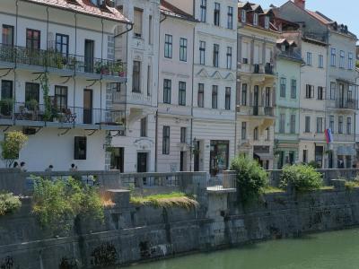 Picturesque view of historic buildings along the Ljubljanica River in Ljubljana, Slovenia.