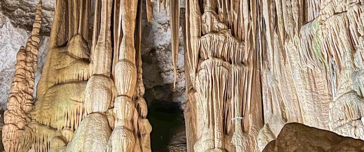 Free Majestic stalactites and stalagmites in a mysterious limestone cave. Stock Photo