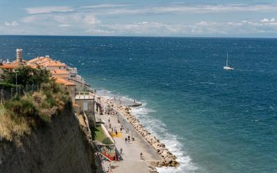 Aerial view of Piran, Slovenia's coastline with azure sea and promenade, perfect for travel inspiration.