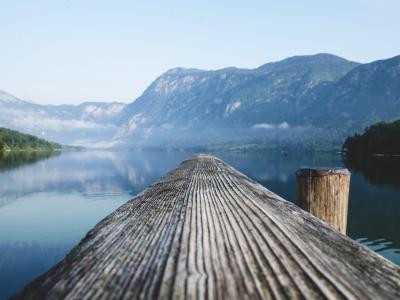 Free Serene view of a mountain lake from a wooden dock in Radovljica, Slovenia. Stock Photo