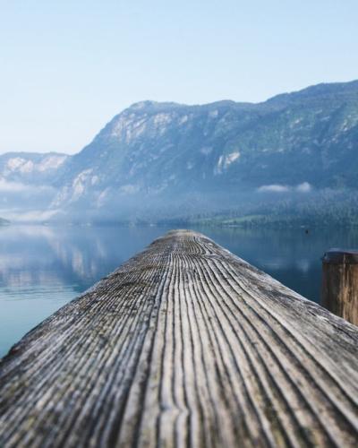 Free Serene view of a mountain lake from a wooden dock in Radovljica, Slovenia. Stock Photo