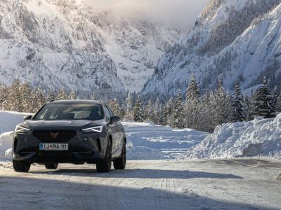 Cupra Formentor driving through snow-covered mountain road in Jesenice, Slovenia.