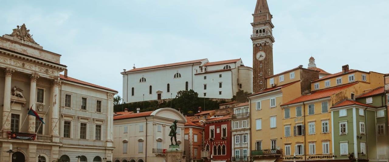 A picturesque view of Tartini Square in Piran featuring historic architecture and the iconic clock tower.