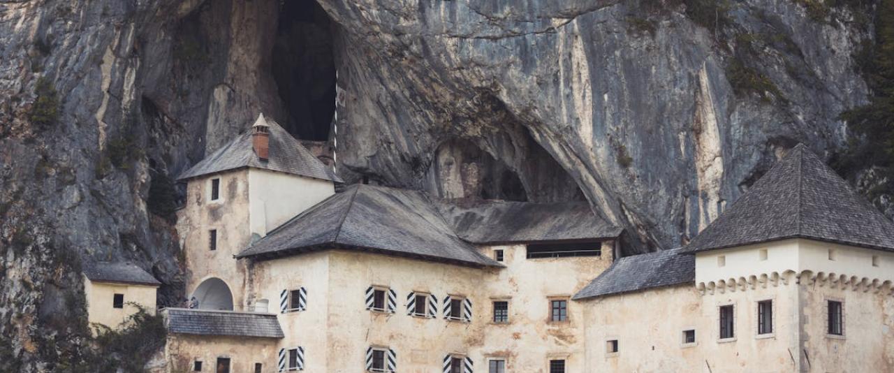 Explore the stunning Predjama Castle built into a cliff face in Slovenia.