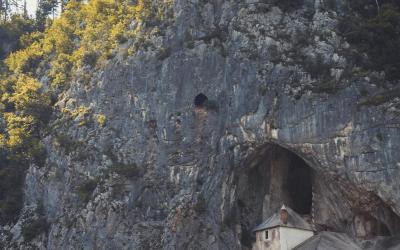 Free Explore the historical Predjama Castle in Slovenia, emerging from a natural cave within a rugged cliff. Stock Photo