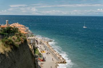 Aerial view of Piran, Slovenia's coastline with azure sea and promenade, perfect for travel inspiration.