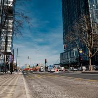 Vibrant urban street view with modern architecture and pedestrians in Ljubljana, Slovenia.