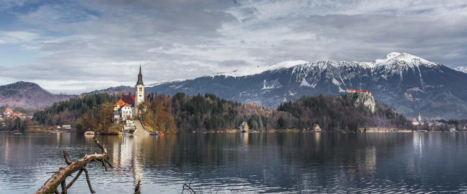Serene winter landscape showcasing Lake Bled and the Alps in Slovenia.