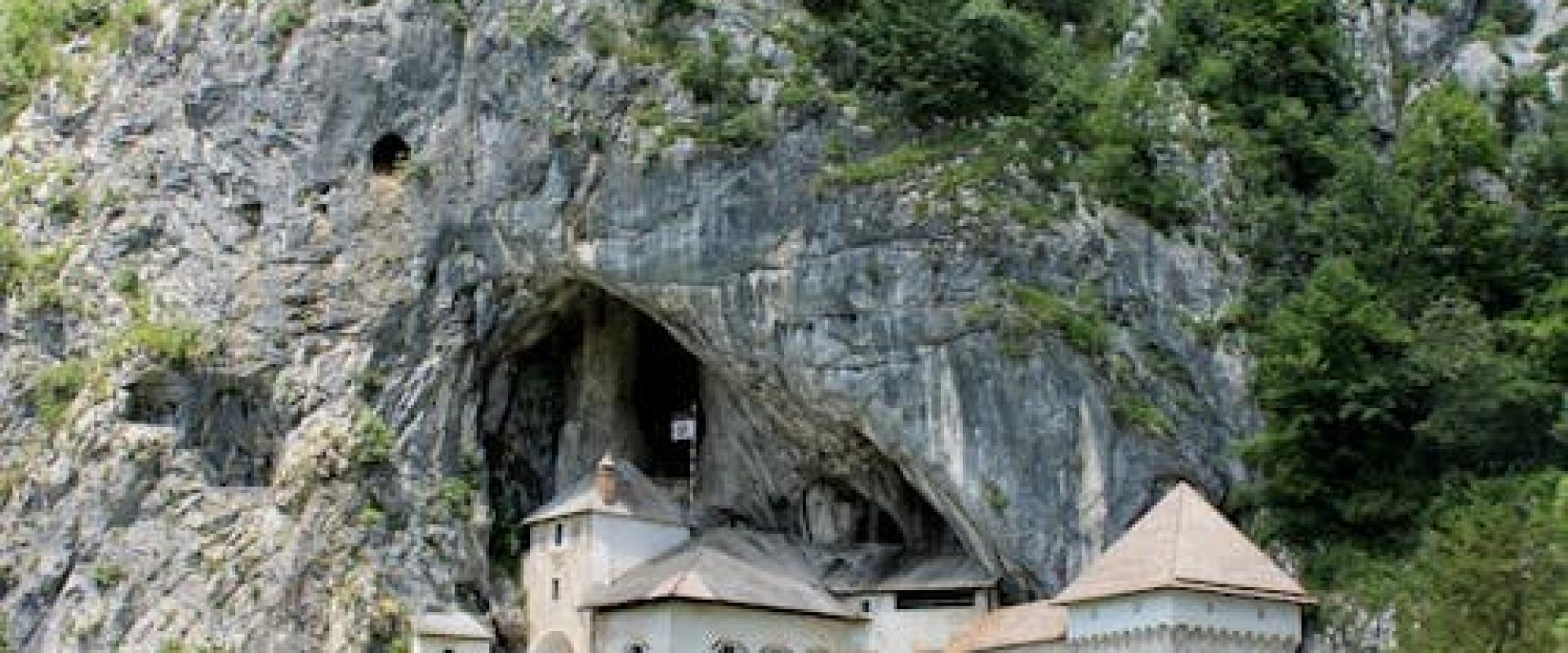 Free Explore the historic Predjama Castle built into the cliffs of Slovenia, surrounded by lush nature. Stock Photo