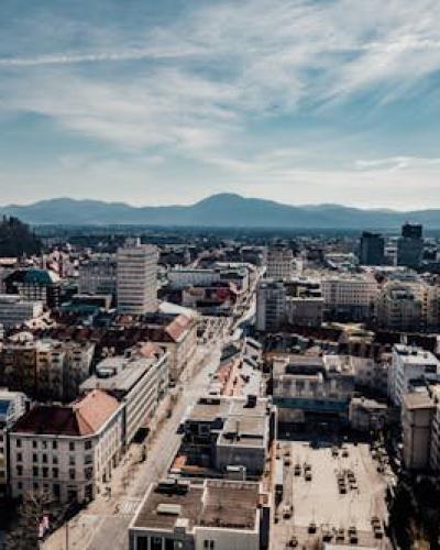 Free A stunning aerial view of Ljubljana, Slovenia featuring the city's buildings, castle, and surrounding mountains. Stock Photo