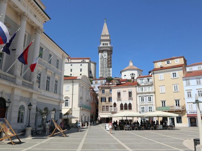Tartini Square in Piran with the bell tower of St. George's Church rising behind Venetian-style buildings