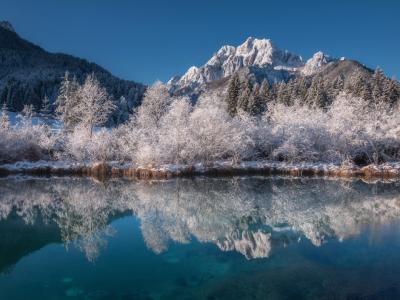 body of water near mountain during daytime