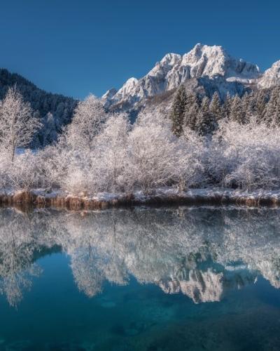 body of water near mountain during daytime