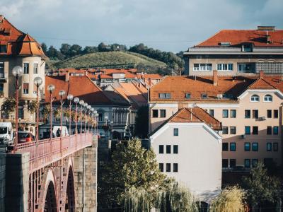 a bridge over a body of water with buildings in the background