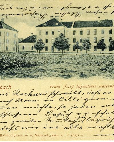 A vintage postcard showing a large, multi-winged institutional building complex with a grassy field in the foreground, featuring printed text "Grüsse aus Laibach" and "Franz Josef Infanterie Kaserne".
