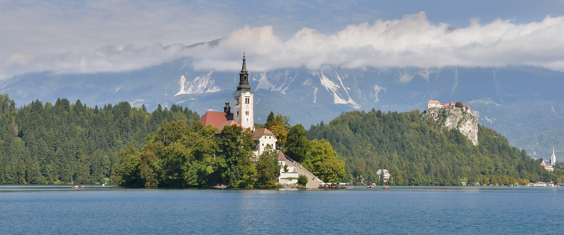 Bled Island with the Church of the Assumption in the middle of Lake Bled, Bled Castle on the cliff behind