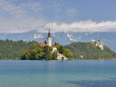 Bled Island with the Church of the Assumption in the middle of Lake Bled, Bled Castle on the cliff behind