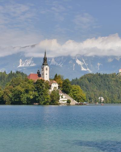Bled Island with the Church of the Assumption in the middle of Lake Bled, Bled Castle on the cliff behind