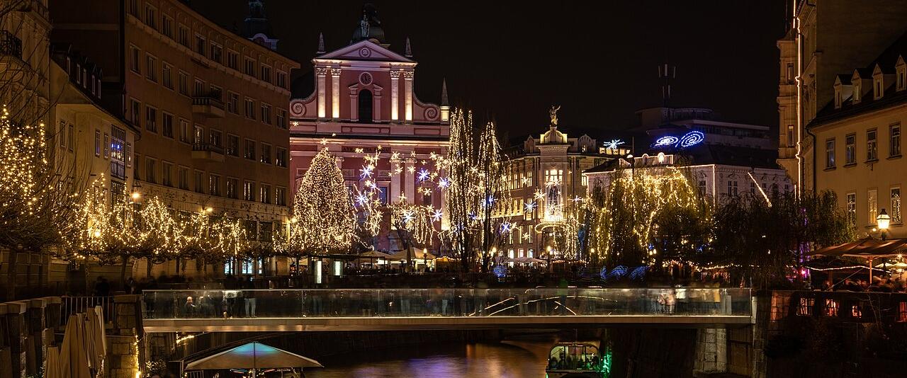 Prešeren Square and the Triple Bridge in Ljubljana lit with Christmas lights at night