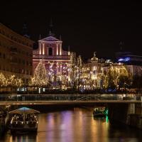 Prešeren Square and the Triple Bridge in Ljubljana lit with Christmas lights at night