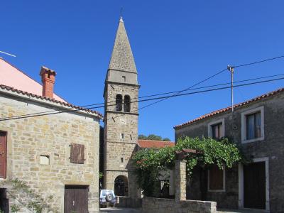 Bell tower of the Church of St. Blaise rising above the stone houses of Padna