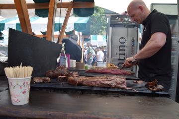 A cook grilling at the Odprta kuhna street-food market in Ljubljana