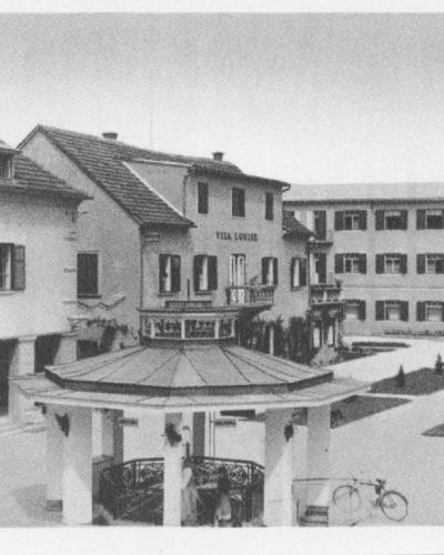 A black-and-white postcard showing a paved courtyard with a central gazebo, flanked by buildings labeled "SLATINSKI DOM," "VILA LOVRE," and "TERAPIJA," with the caption "Slatina Radenci" at the bottom.
