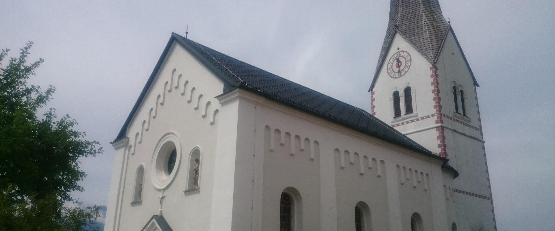 The white parish church of Šentanel in Koroška