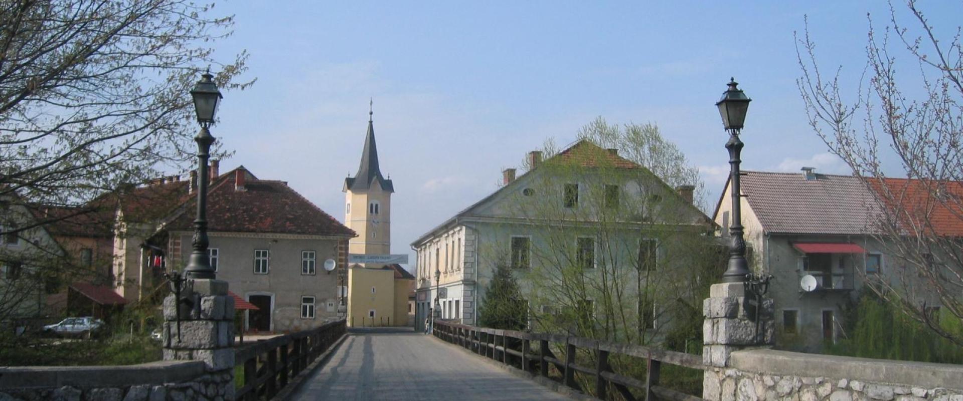 The bridge and church tower of the island town of Kostanjevica na Krki
