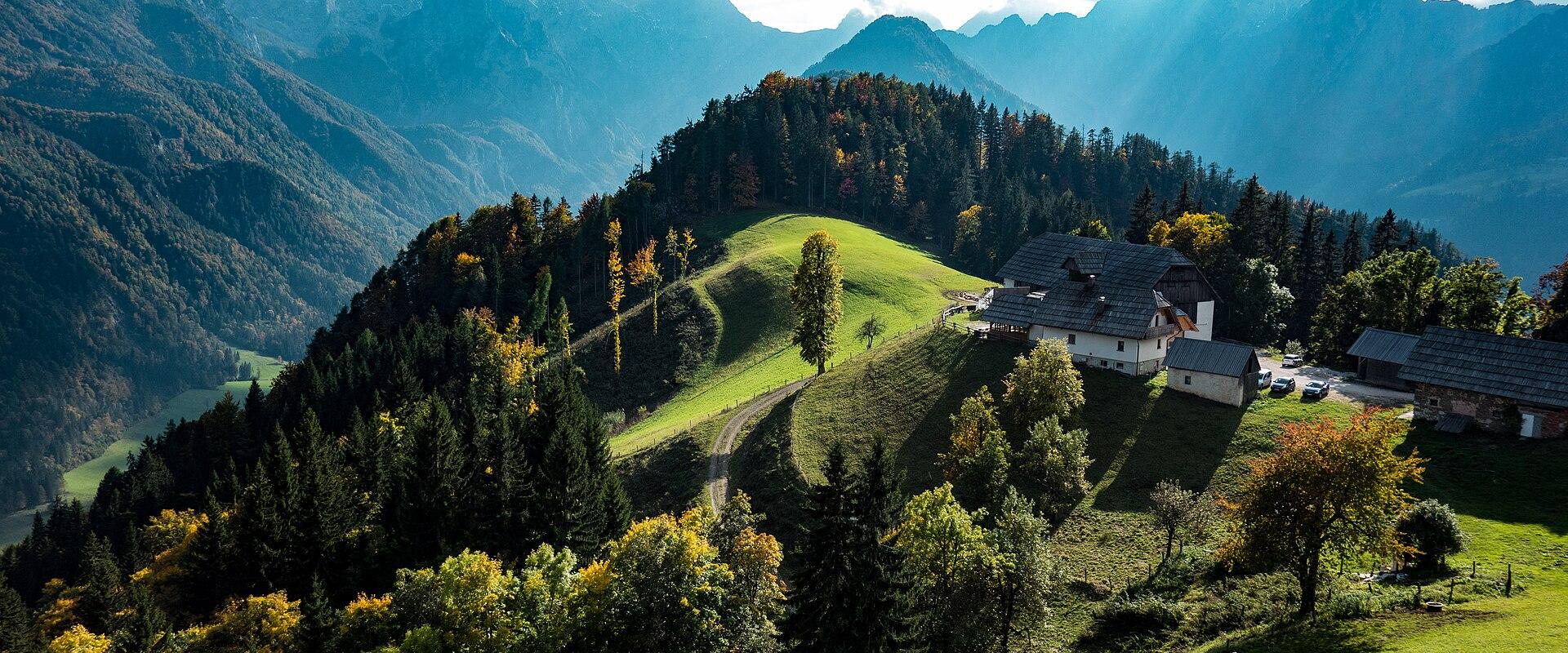 Green pastures below the Kamnik–Savinja Alps around Solčava
