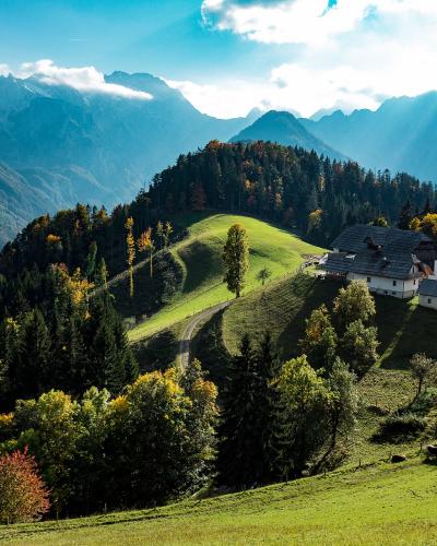 Green pastures below the Kamnik–Savinja Alps around Solčava