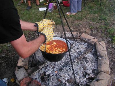 Bograč stew cooking in a cauldron over an open fire